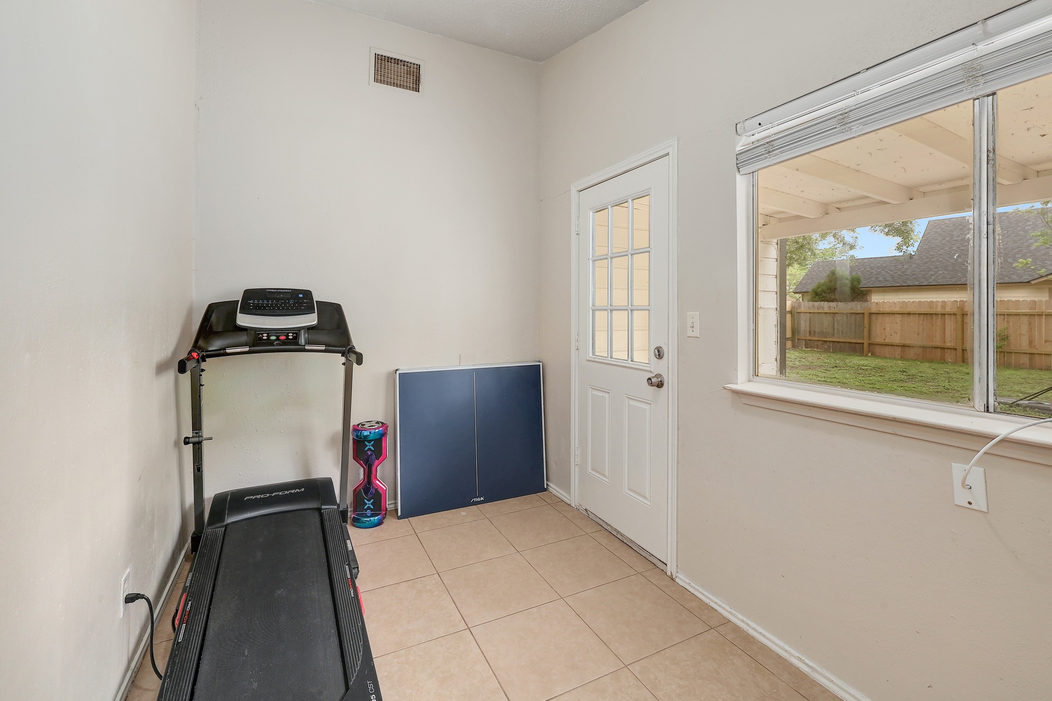9901 Parliament House Road Austin, TX 78729 - Photo 32 of 40 Exercise area featuring baseboards and light tile patterned flooring