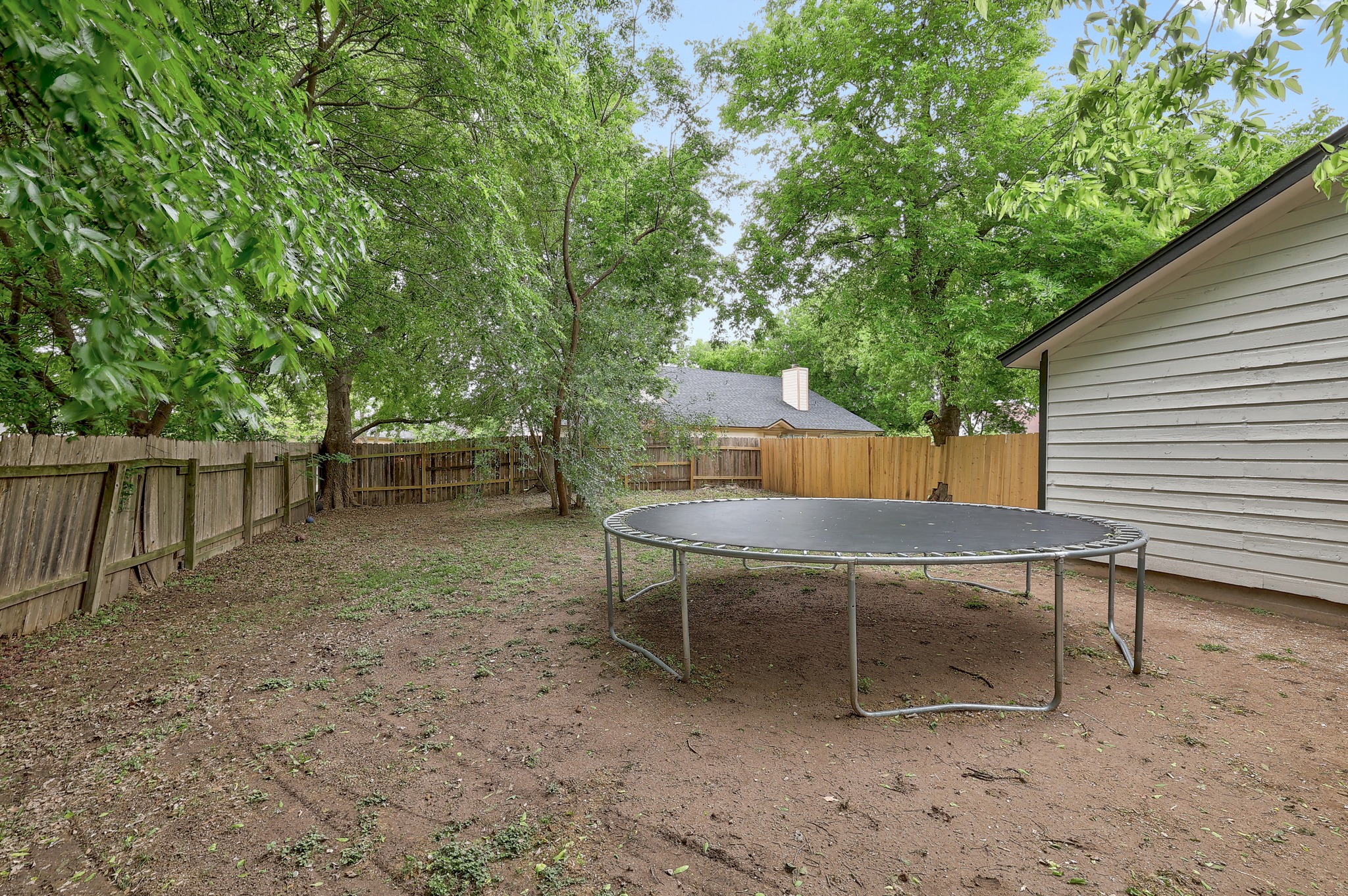 9901 Parliament House Road Austin, TX 78729 - Photo 34 of 40 Fenced backyard with a trampoline