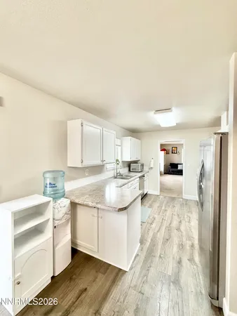a large white kitchen with a stove and a refrigerator
