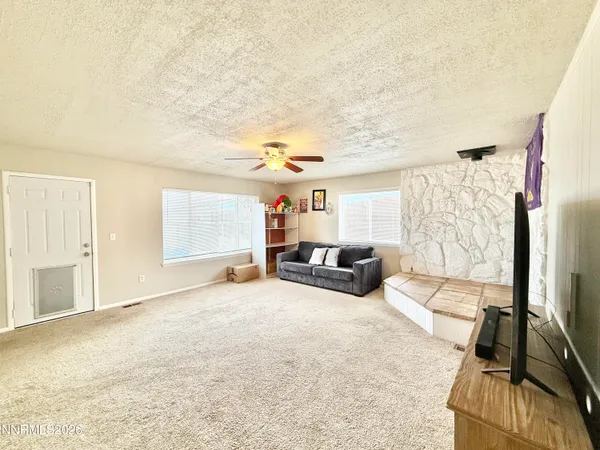 a view of a livingroom with furniture and a flat screen tv