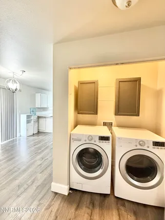 a view of a kitchen with wooden floor and washer dryer