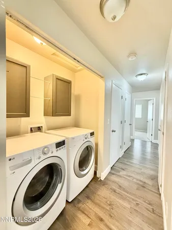 a view of a hallway with washer and dryer
