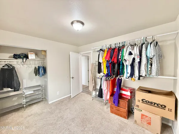 a view of walk in closet with clothes