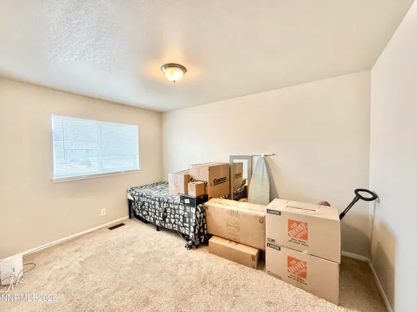 a bed room with bed and window