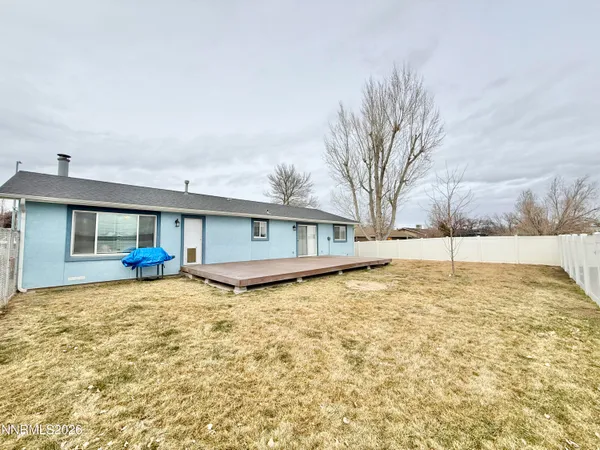 a view of a house with a yard covered in snow