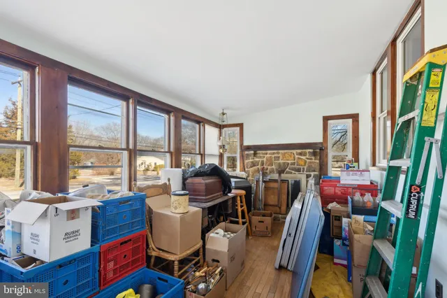a living room with furniture a flat screen tv and large windows