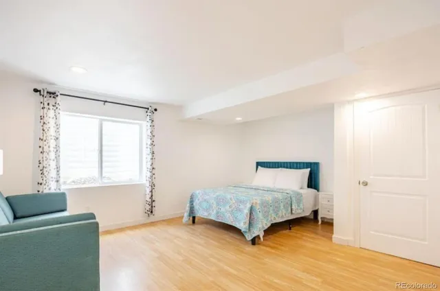 a bedroom with a bed and a couch