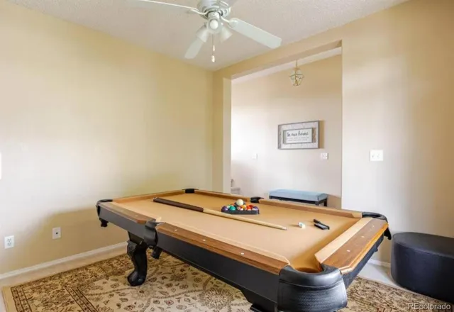 a room with pool table and windows