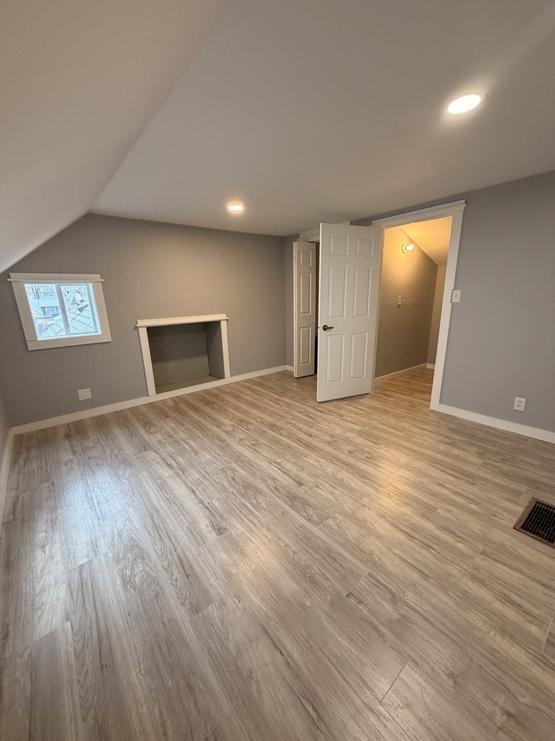 1024 South Warren Street Peoria, IL 61605 - Photo 10 of 14 a view of an empty room with window and wooden floor