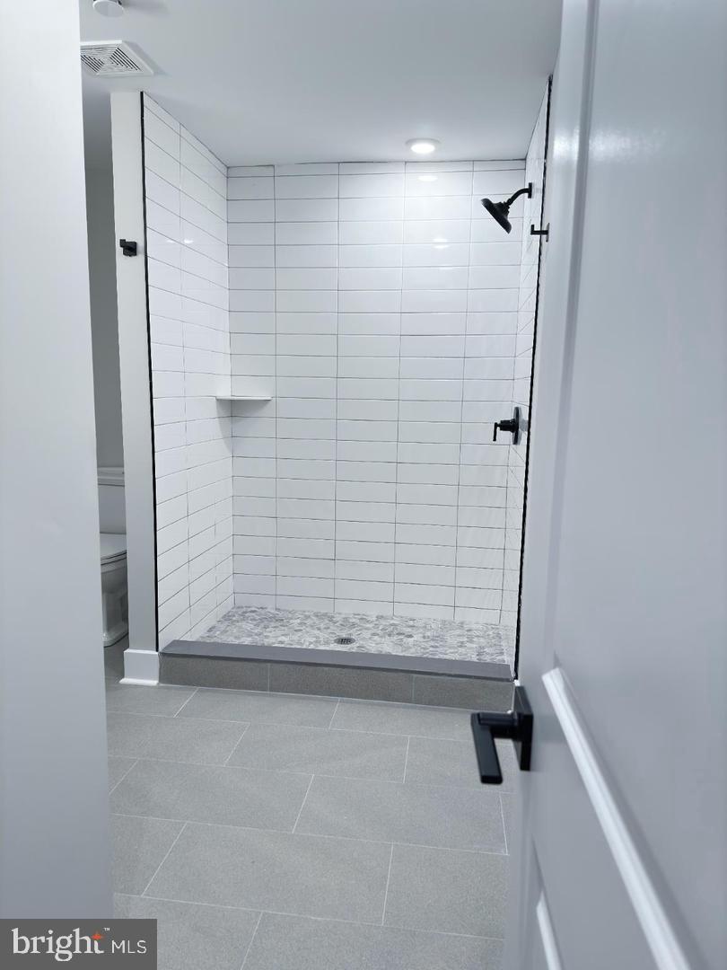 1722 Master Street, Unit 1 Philadelphia, PA 19121 - Photo 9 of 10 Sleek modern shower with elegant tiles.