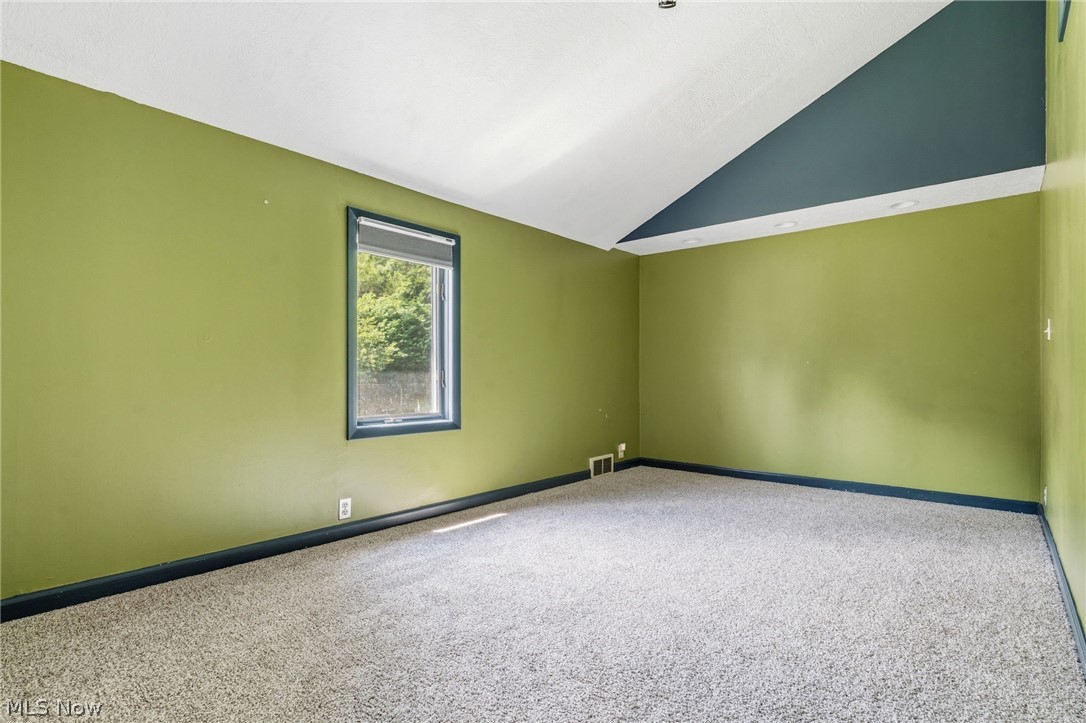 4449 18th Street Northwest Canton, OH 44708 - Photo 10 of 25 Room featuring sloped ceilings, a single window, and neutral carpet flooring