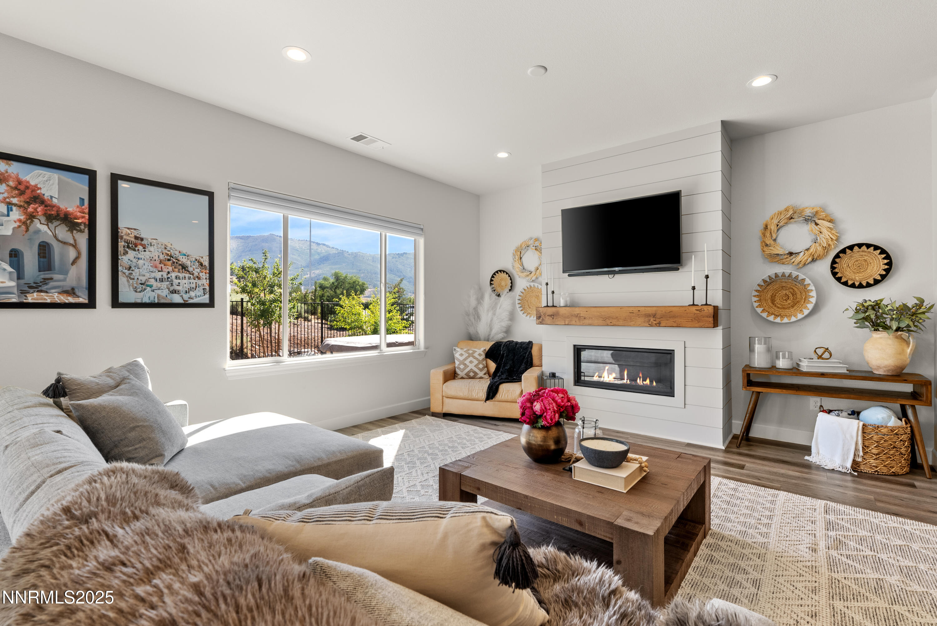 a living room with furniture a flat screen tv and a fireplace