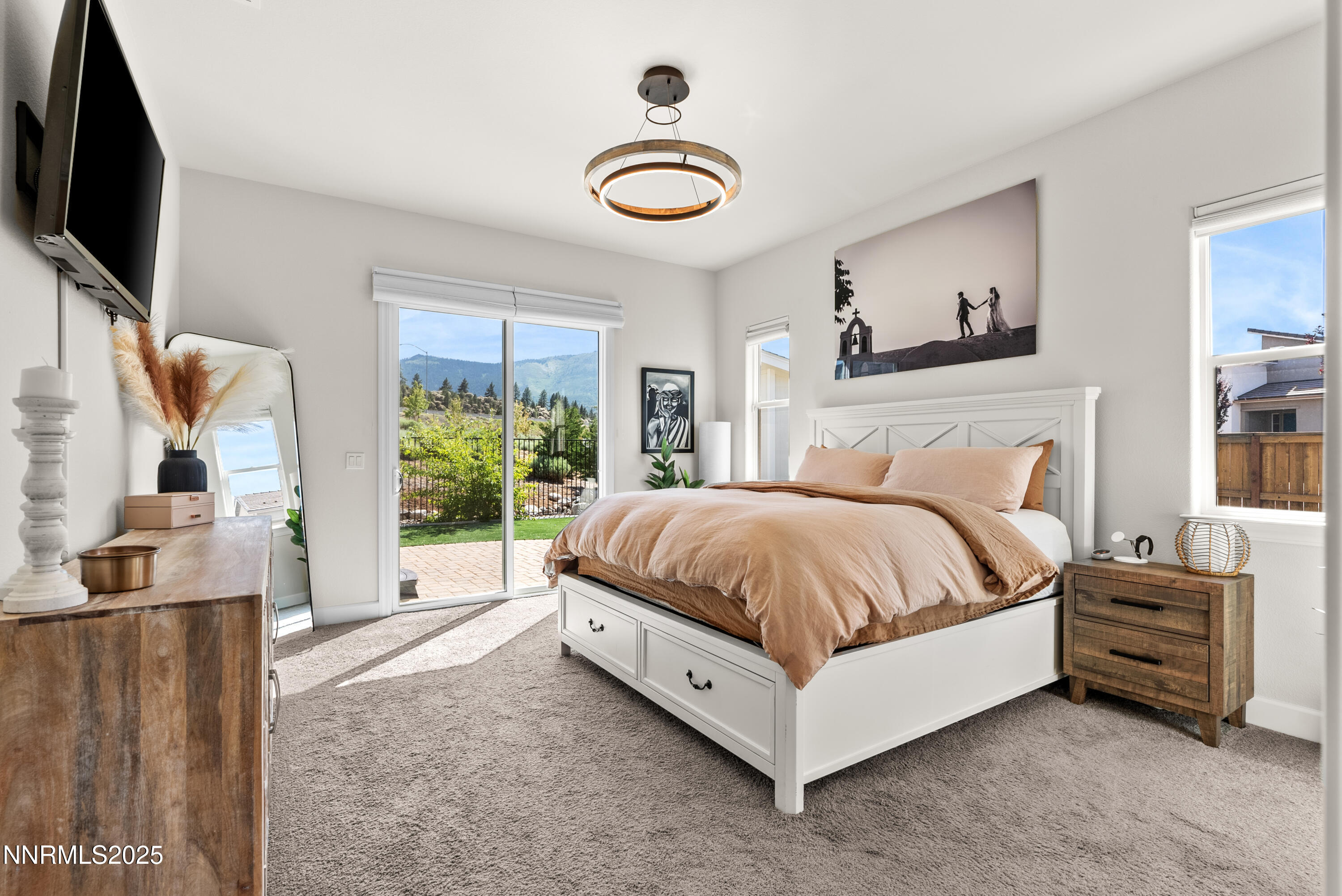 8650 Gasparilla Way Reno, NV 89439 - Photo 13 of 29 a spacious bedroom with a bed and a flat tv screen on the dresser