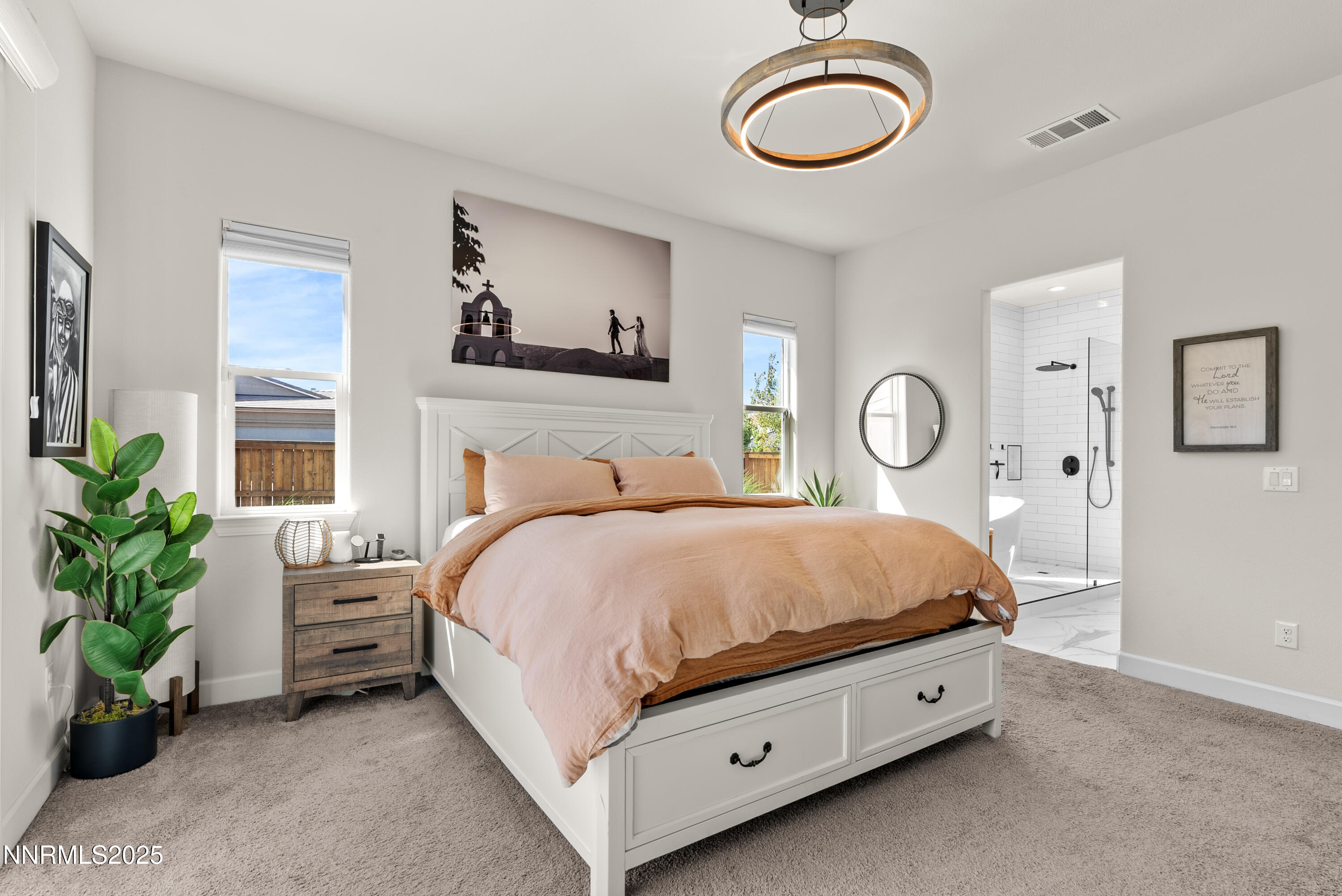 8650 Gasparilla Way Reno, NV 89439 - Photo 14 of 29 a bedroom with a bed and a chandelier