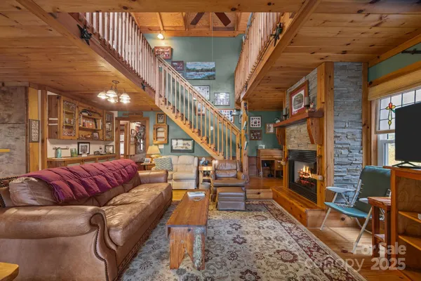 a living room with furniture a fireplace and a chandelier