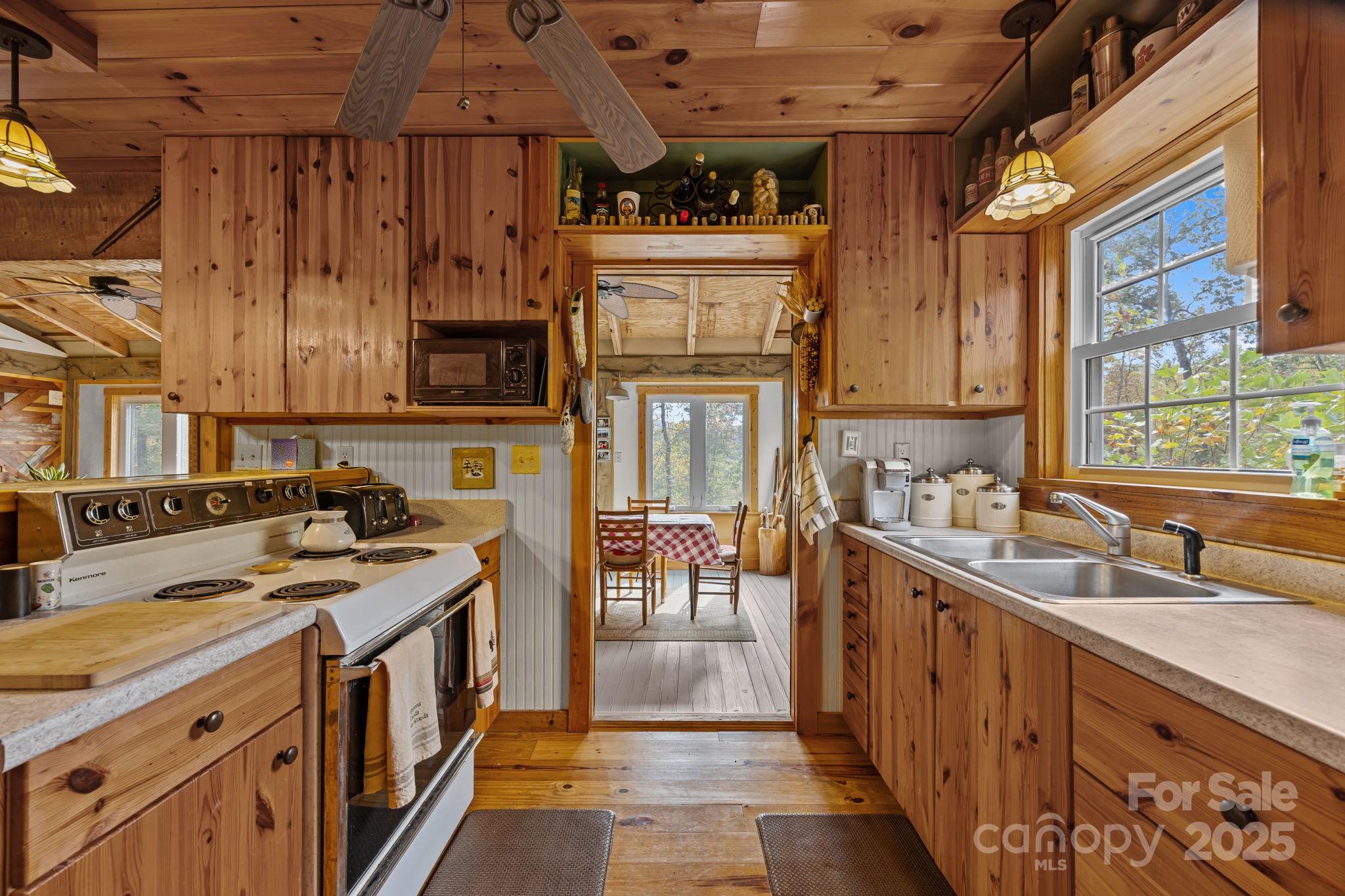 38 Buzzards Rst Trail, Unit 7 Saluda, NC 28773 - Photo 23 of 47 a kitchen with stainless steel appliances granite countertop a stove and a sink