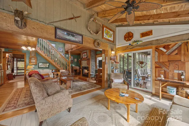 a living room with lots of furniture and a large window