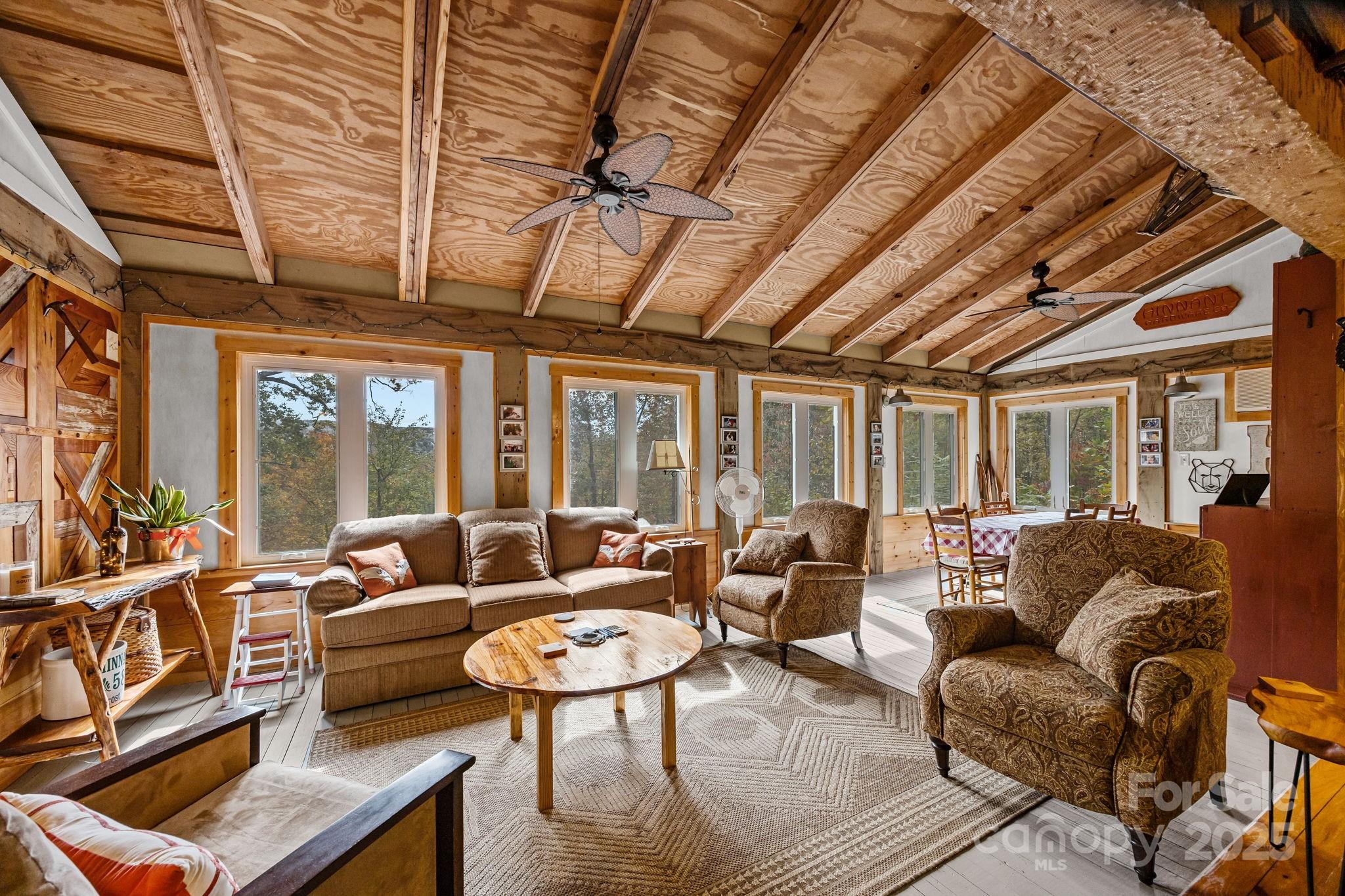 38 Buzzards Rst Trail, Unit 7 Saluda, NC 28773 - Photo 26 of 47 a living room with furniture and a large window