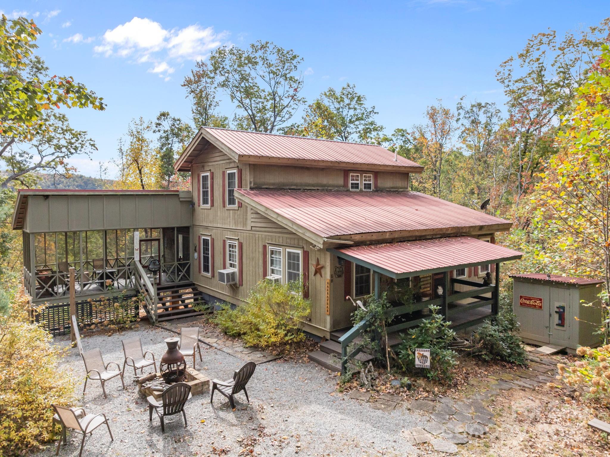 38 Buzzards Rst Trail, Unit 7 Saluda, NC 28773 - Photo 3 of 47 a view of house with table and chairs under an umbrella