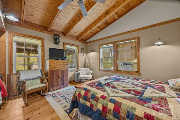 a bedroom with bed and a large window