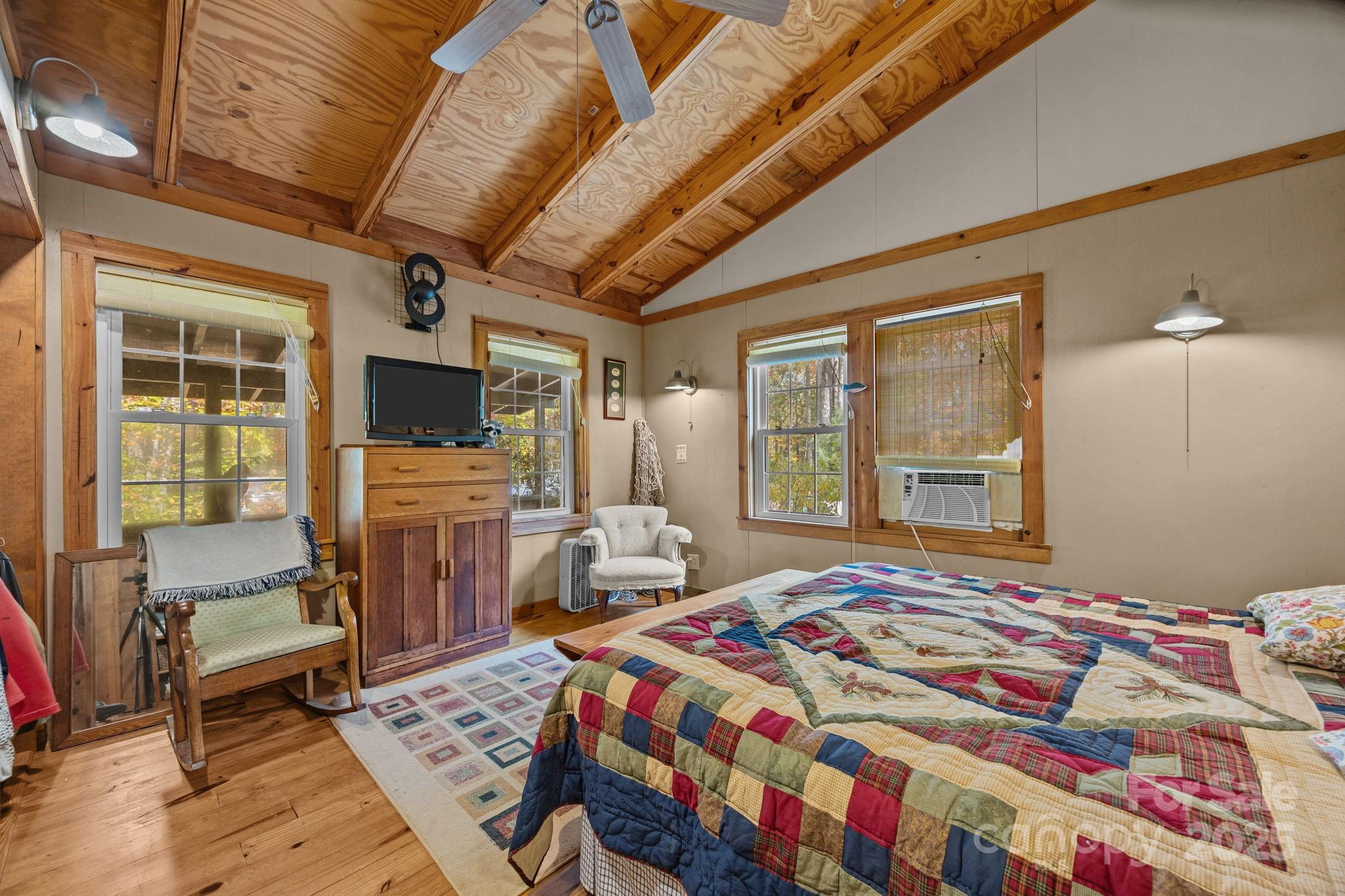 38 Buzzards Rst Trail, Unit 7 Saluda, NC 28773 - Photo 31 of 47 a bedroom with a bed and wooden floor