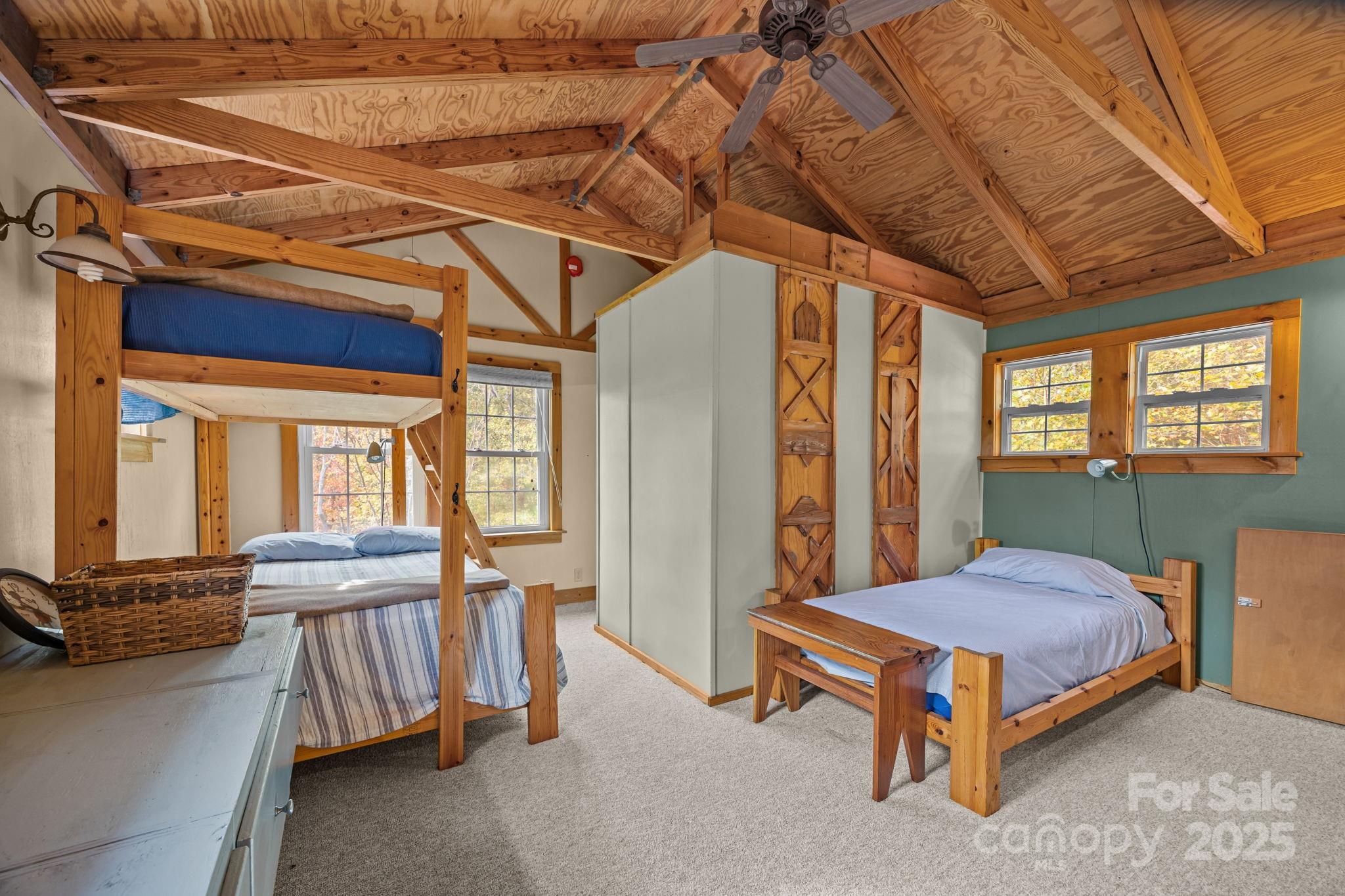 38 Buzzards Rst Trail, Unit 7 Saluda, NC 28773 - Photo 36 of 47 a bedroom with furniture and large windows