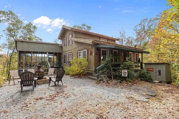a view of house with a chairs and table in a patio