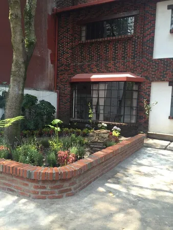a view of a small house with a yard