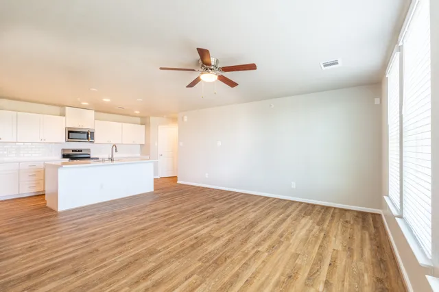 a view of kitchen with wooden floor and window