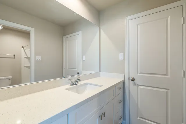a bathroom with a sink double vanity and a mirror