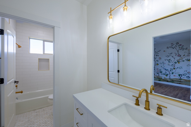 868 Braddock Lane Alpine, UT 84004 - Photo 37 of 64 Contemporary bathroom featuring a white vanity with integrated sink, gold-finish fixtures, and a large framed mirror