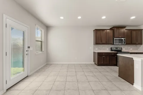 a kitchen with stainless steel appliances a refrigerator and a stove top oven