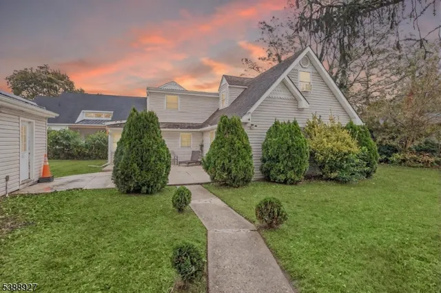 a front view of house with a garden