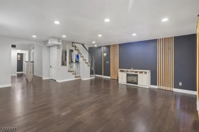a view of a kitchen with a fridge and wooden floor