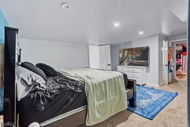 a bedroom with a bed and a flat screen television