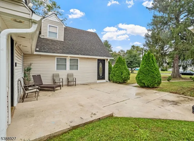 a backyard of a house with table and chairs