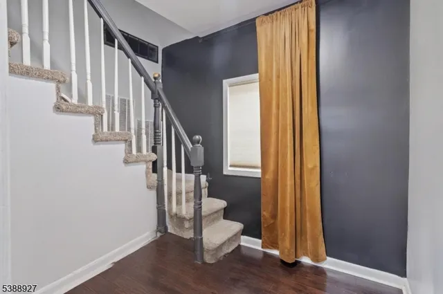 a view of entryway with wooden floor and stairs