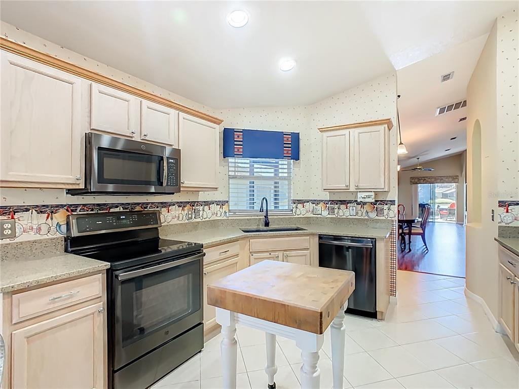 121 Rialto Road Poinciana, FL 34759 - Photo 11 of 68 a kitchen with a stove and a microwave