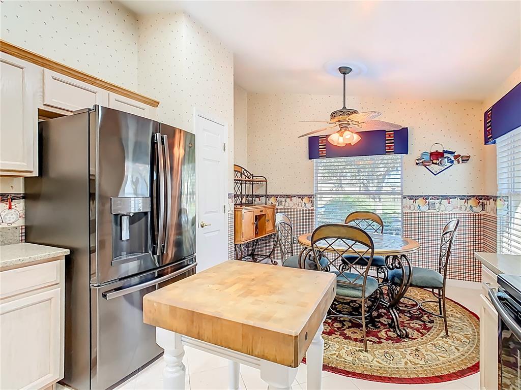 121 Rialto Road Poinciana, FL 34759 - Photo 14 of 68 a kitchen with a refrigerator and a stove top oven