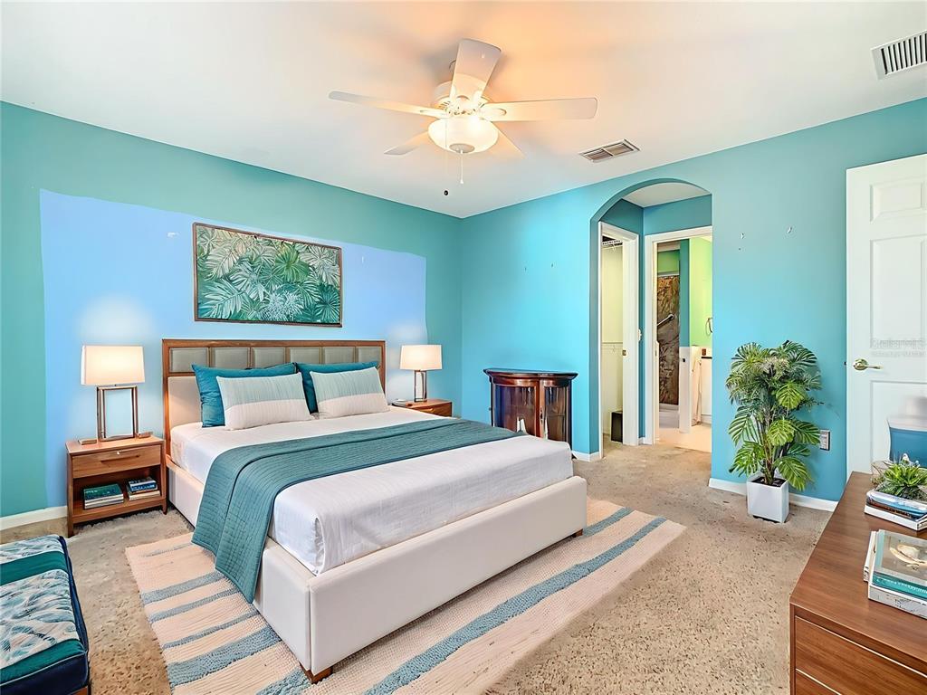 121 Rialto Road Poinciana, FL 34759 - Photo 18 of 68 a bedroom with bed and a chandelier