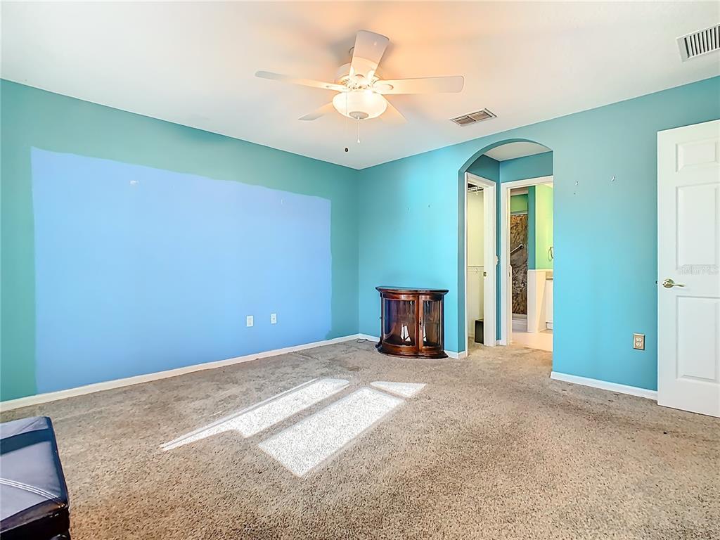 121 Rialto Road Poinciana, FL 34759 - Photo 19 of 68 an empty room with windows and a ceiling fan