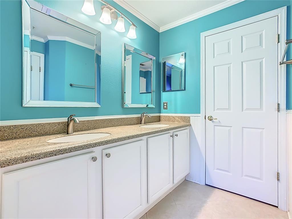 121 Rialto Road Poinciana, FL 34759 - Photo 22 of 68 a bathroom with a double vanity sink and a mirror