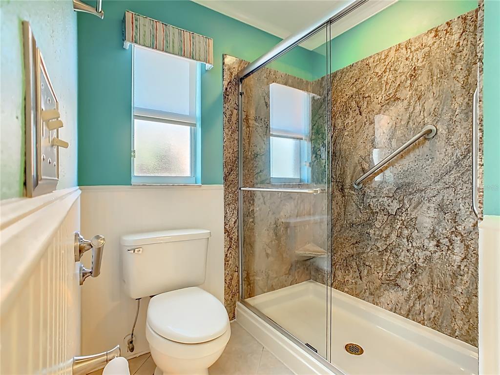 121 Rialto Road Poinciana, FL 34759 - Photo 23 of 68 a bathroom with a toilet and a shower