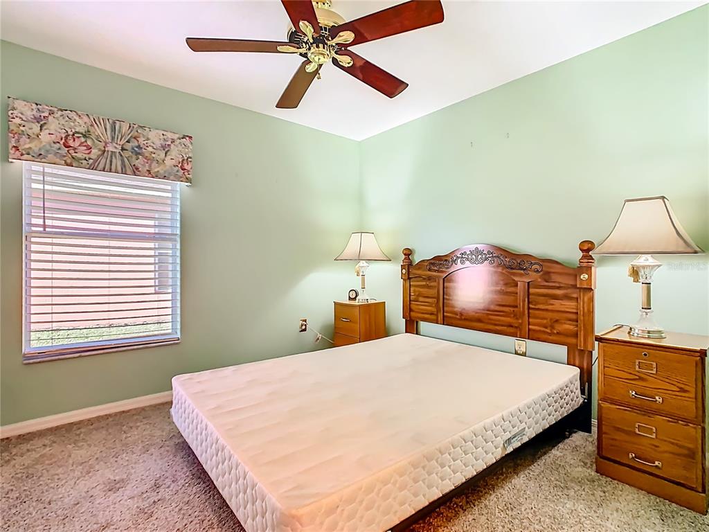 121 Rialto Road Poinciana, FL 34759 - Photo 28 of 68 a bedroom with a bed and ceiling fan