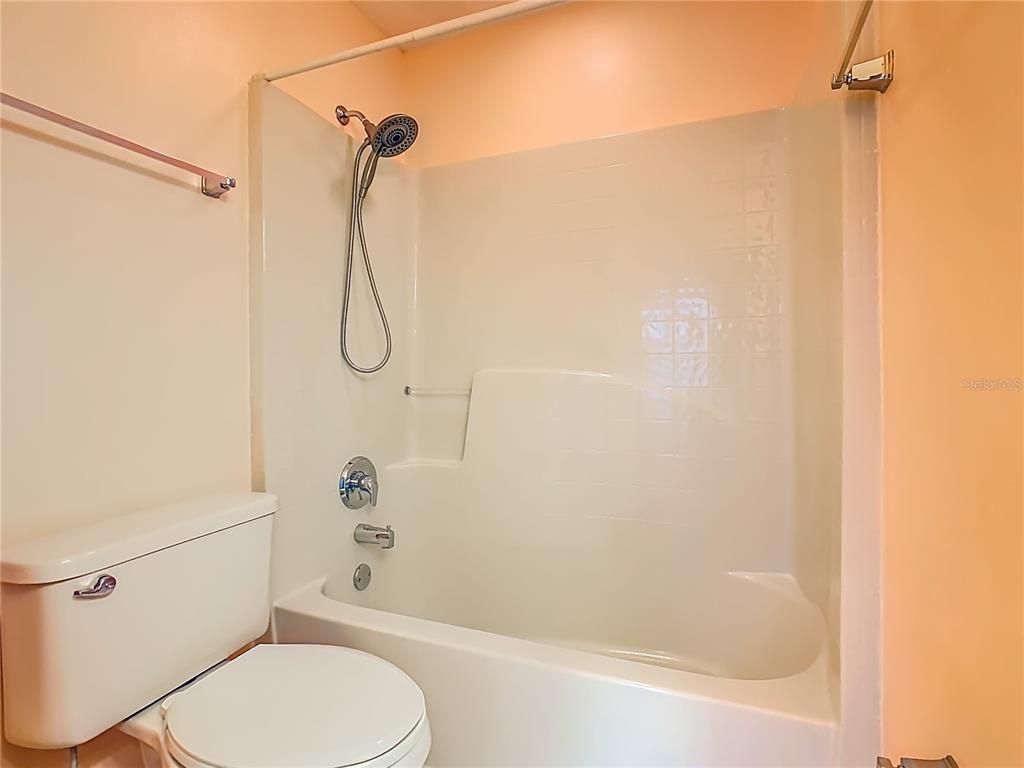 121 Rialto Road Poinciana, FL 34759 - Photo 30 of 68 a bathroom with a shower a toilet and a shower