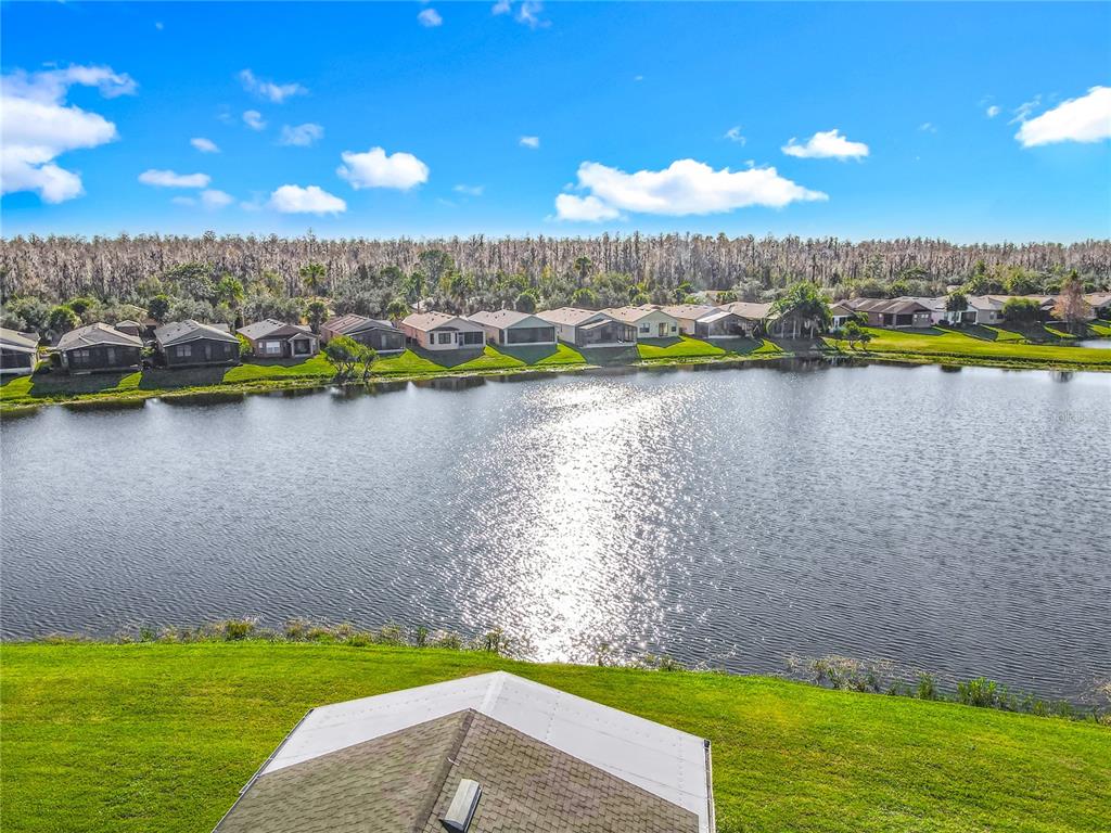 121 Rialto Road Poinciana, FL 34759 - Photo 3 of 68 a view of a lake with houses in the background