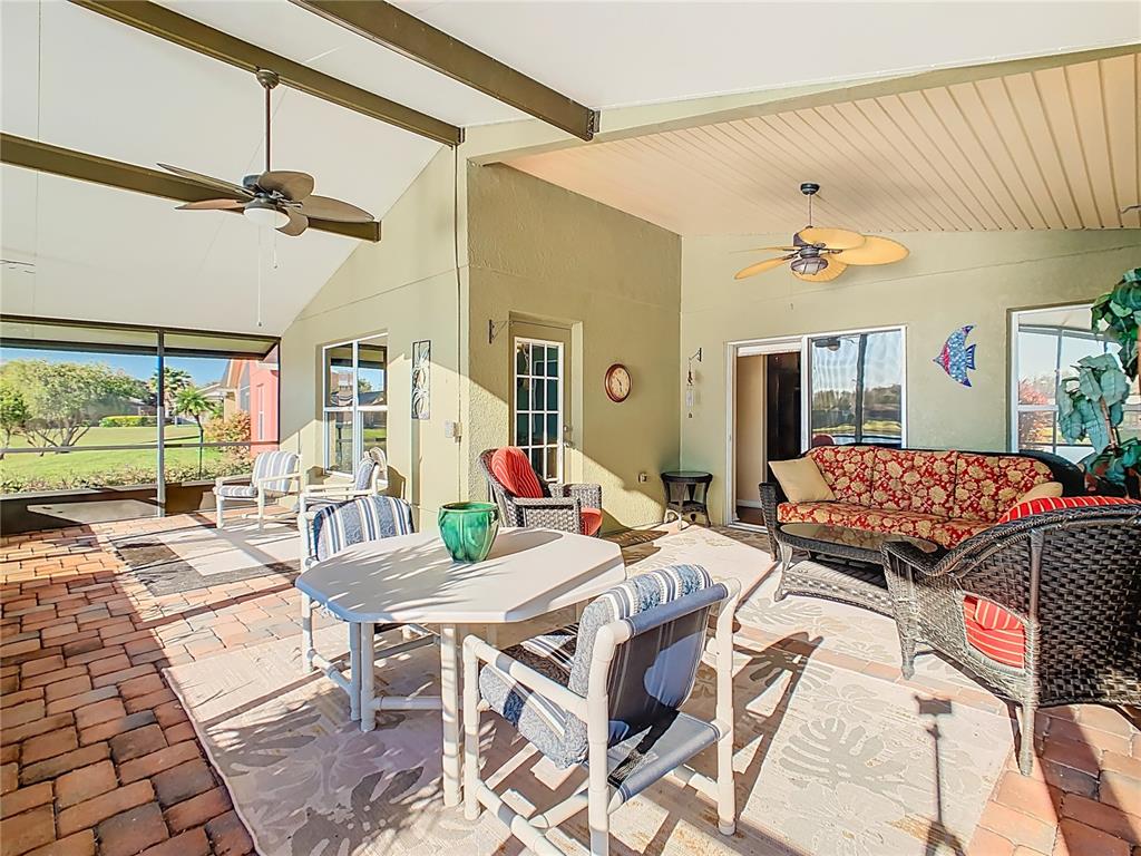 121 Rialto Road Poinciana, FL 34759 - Photo 34 of 68 a living room with furniture and a floor to ceiling window