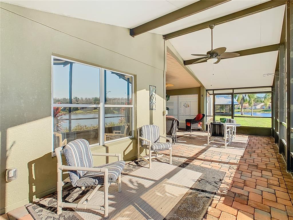 121 Rialto Road Poinciana, FL 34759 - Photo 36 of 68 a living room with furniture a floor to ceiling window and floor to ceiling window
