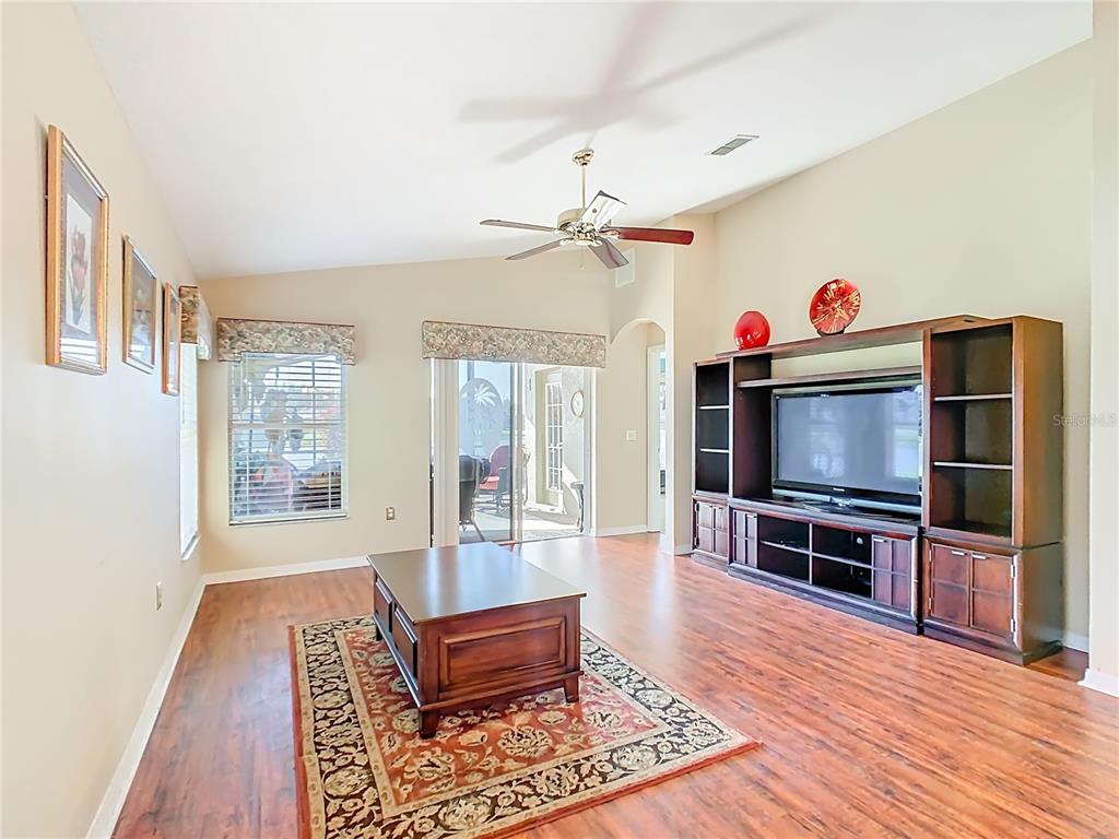 121 Rialto Road Poinciana, FL 34759 - Photo 6 of 68 a living room with furniture and a flat screen tv