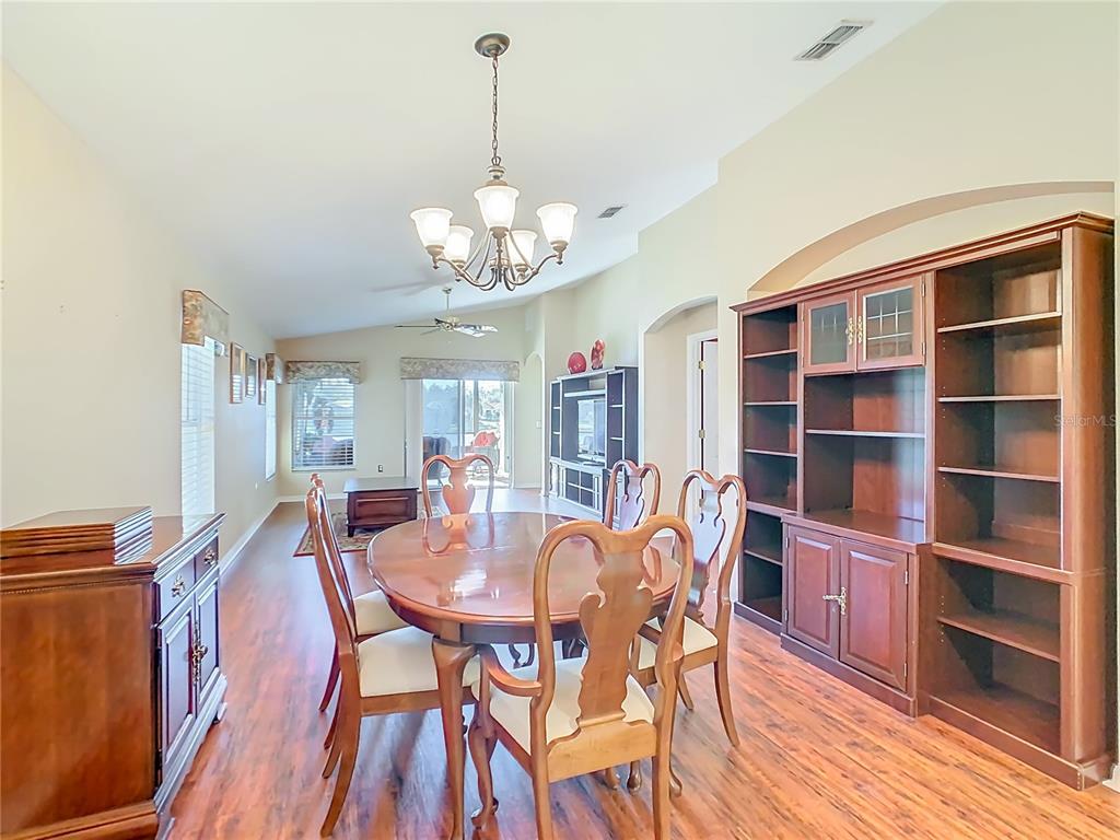 121 Rialto Road Poinciana, FL 34759 - Photo 8 of 68 a view of a dining room with furniture window and wooden floor